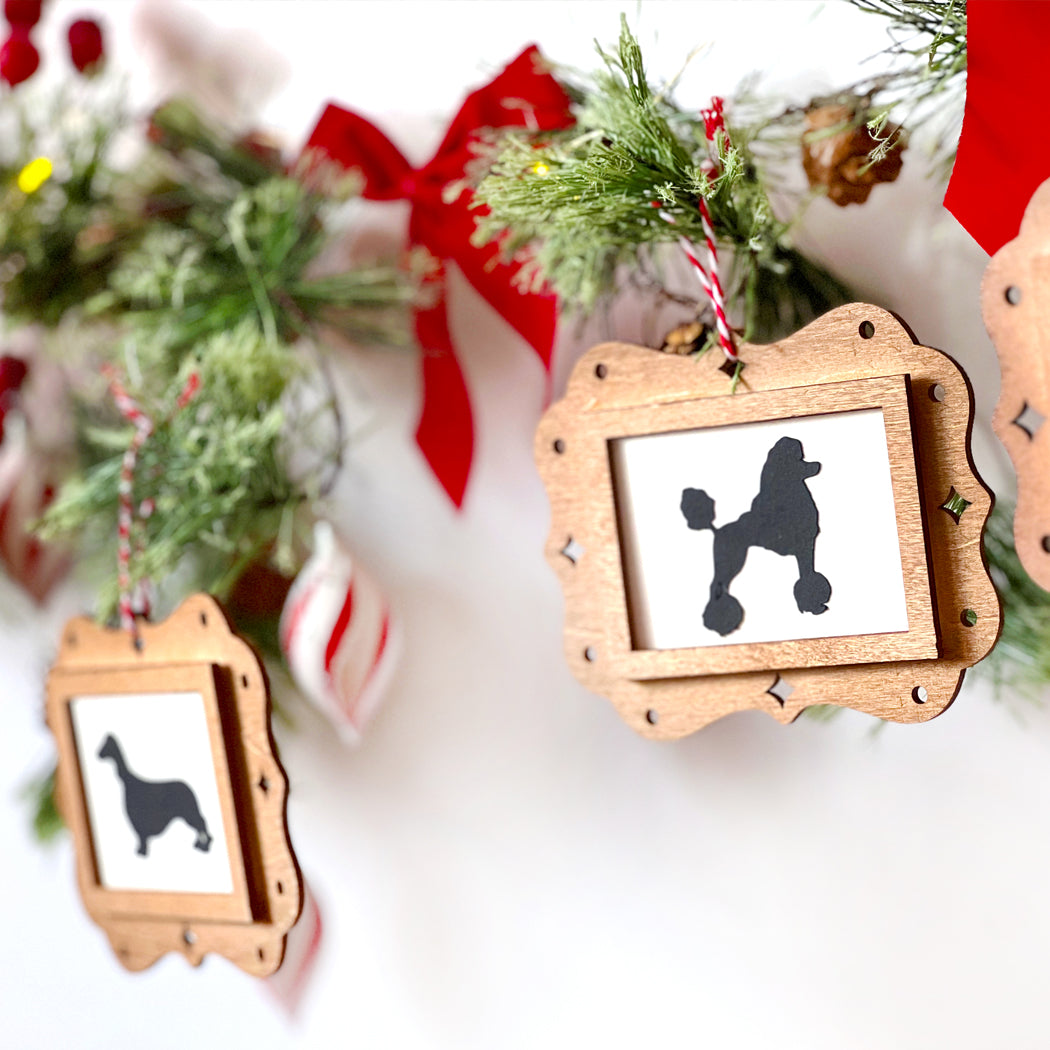 Wooden ornament with poodle silhouette on a Christmas-themed background