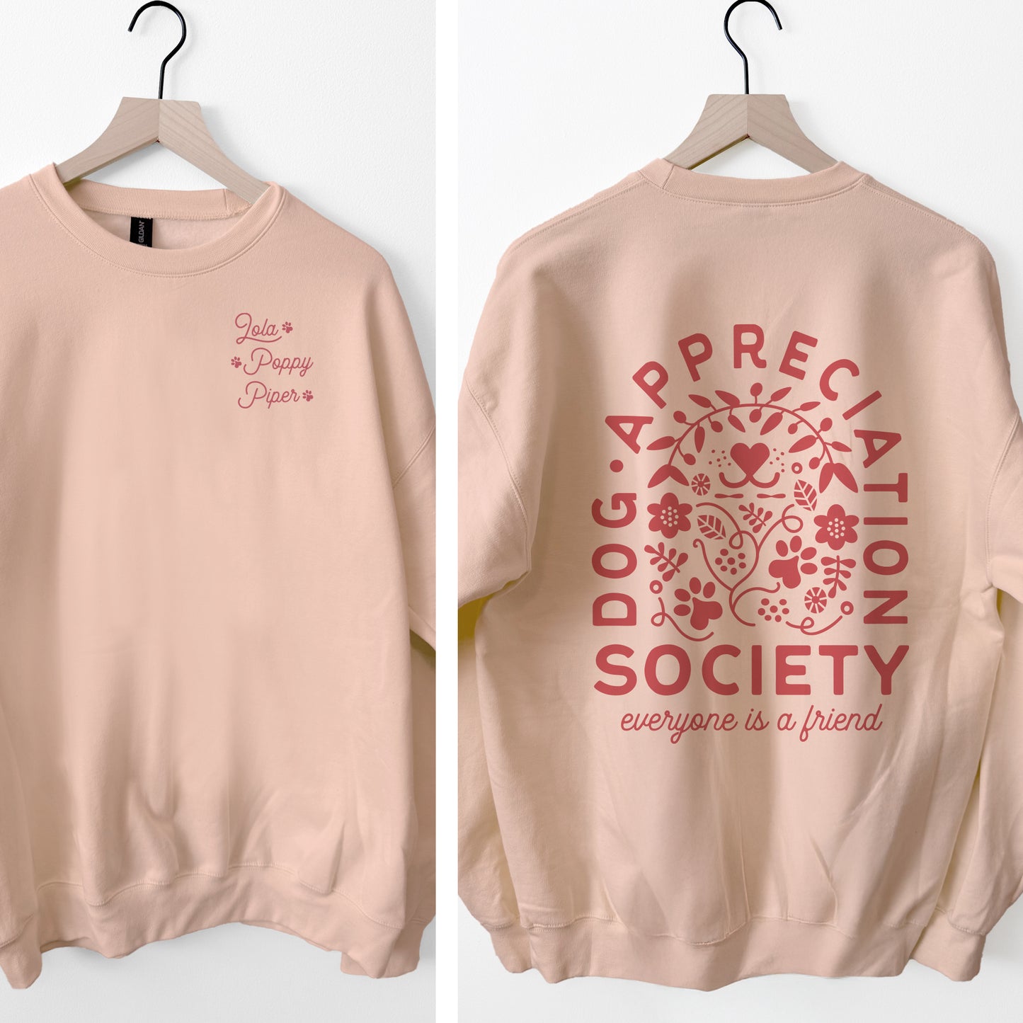 Pink sweatshirt with 'Dog Appreciation Society' text and design on a white background