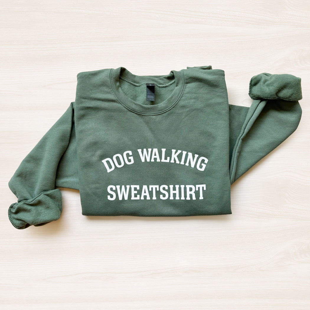 Green sweatshirt with 'DOG WALKING SWEATSHIRT' text on a light background