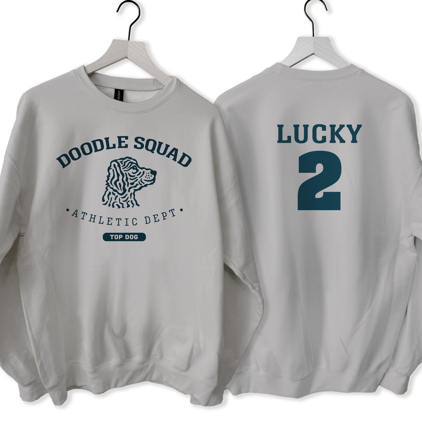 Gray sweatshirt with 'Doodle Squad' and 'Lucky 2' text on hangers against a white background