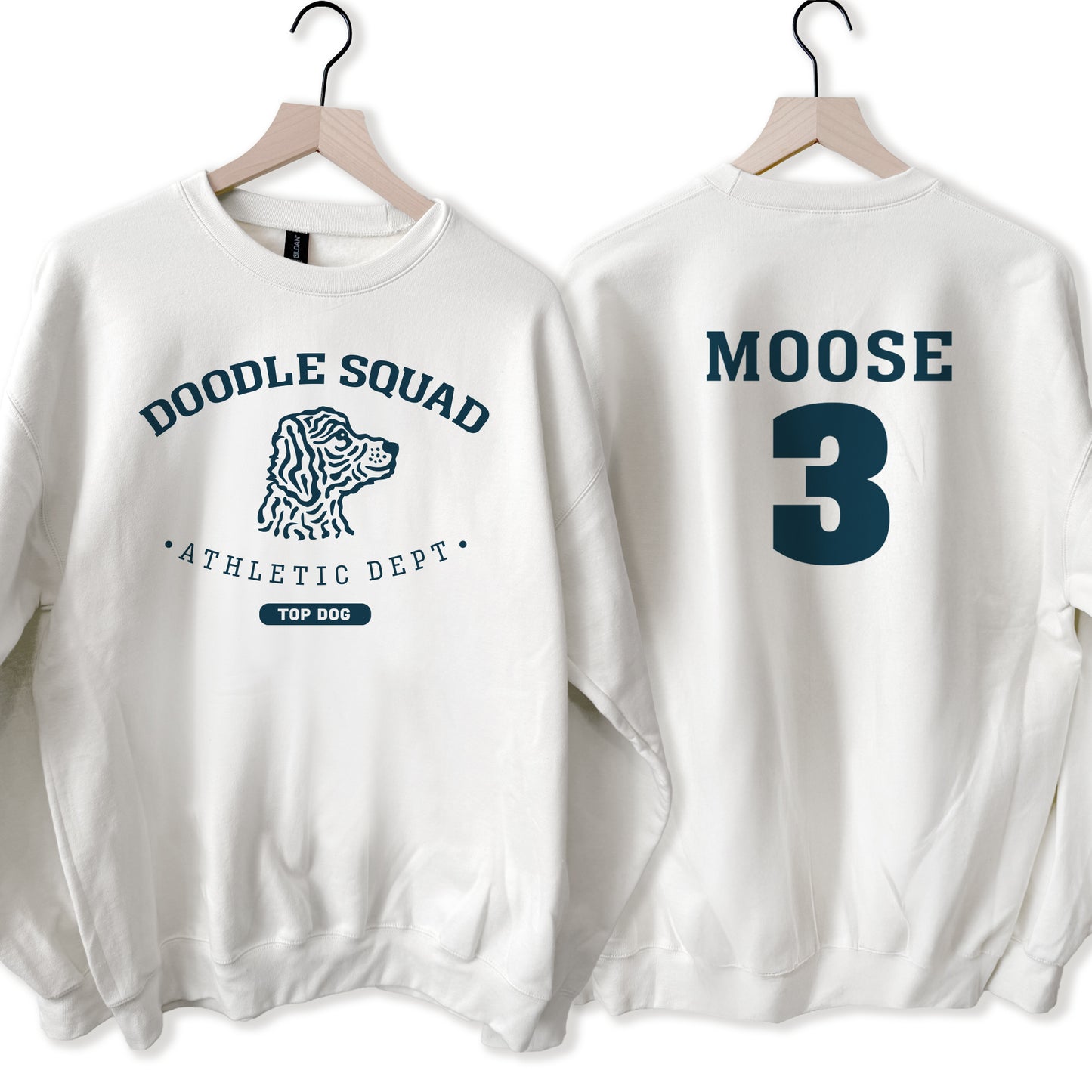 Two white sweatshirts with 'Doodle Squad Athletic Dept' and 'Moose 3' text on hangers.