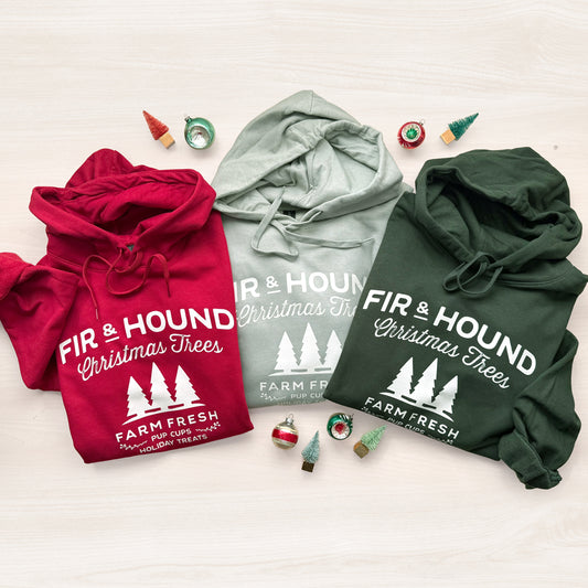 Three hoodies in red, sage, and forest green with 'Fir & Hound Christmas Trees' graphic.