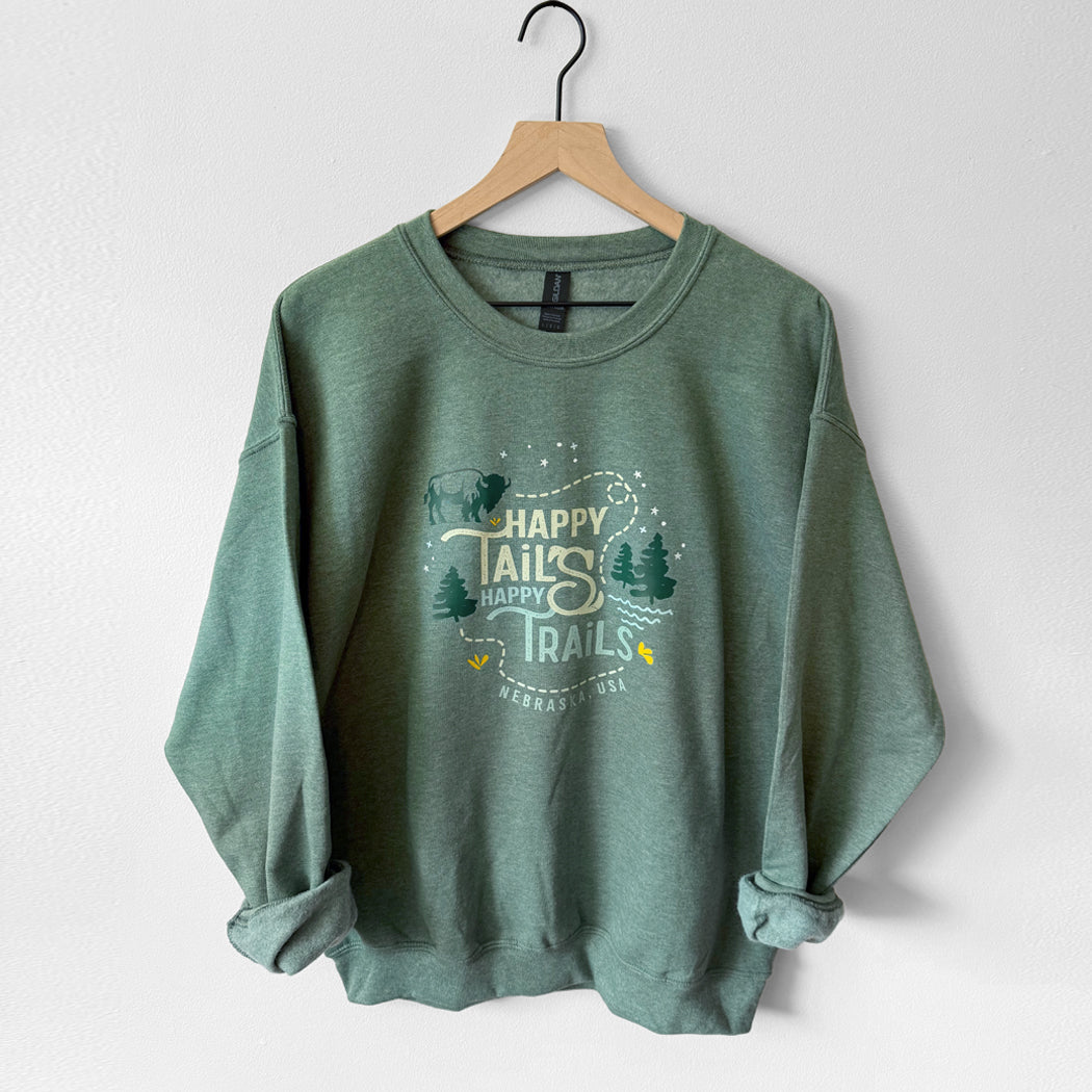 Green sweatshirt with 'Happy Trails' text on a hanger against a white background