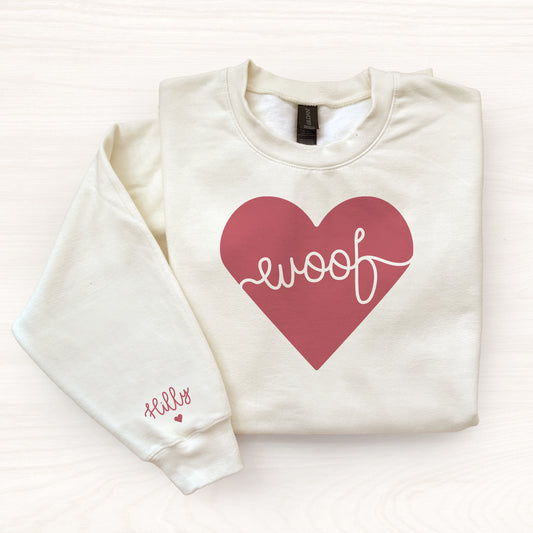Off whtie sweatshirt with a red heart and 'woof' text on a white background
