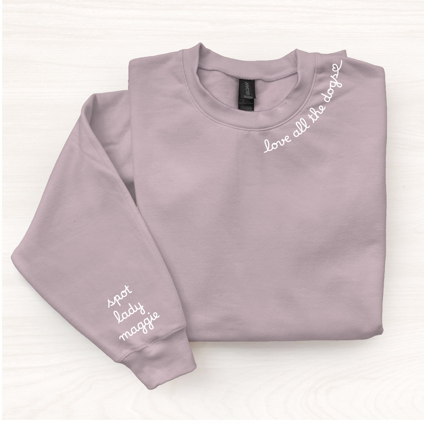 Folded light purple sweatshirt with text on a white background