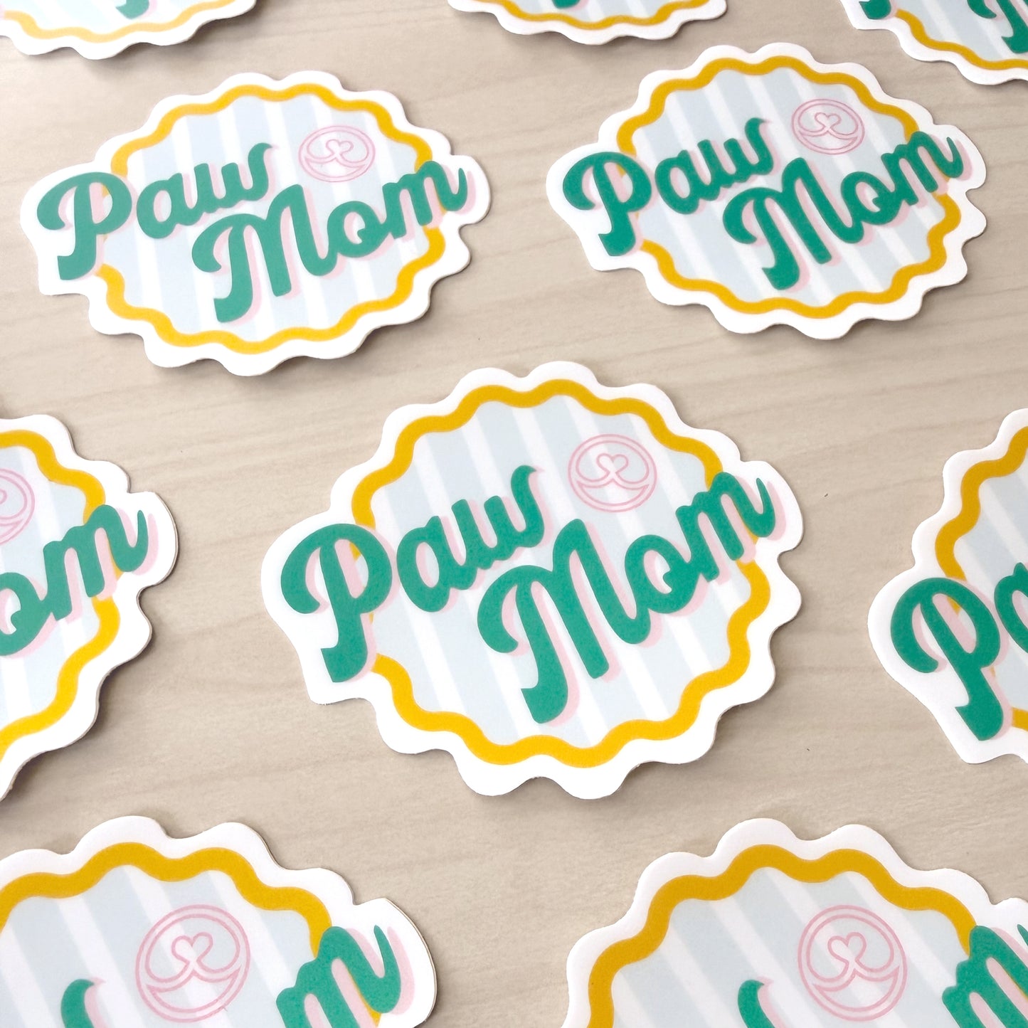 Stickers with 'Paw Mom' text on a beige background