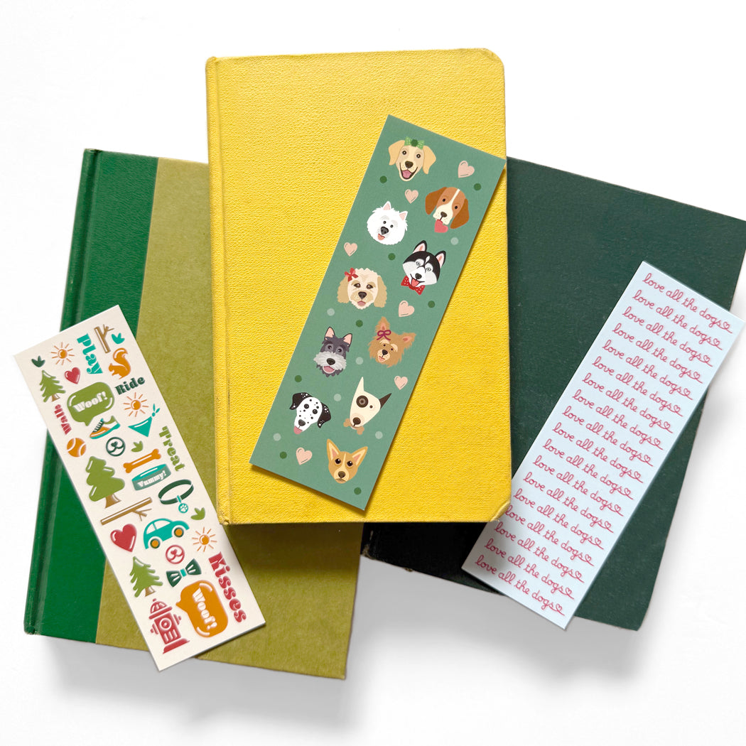 Set of three dog-themed bookmarks with cute illustrations and playful phrases, perfect for dog lovers.