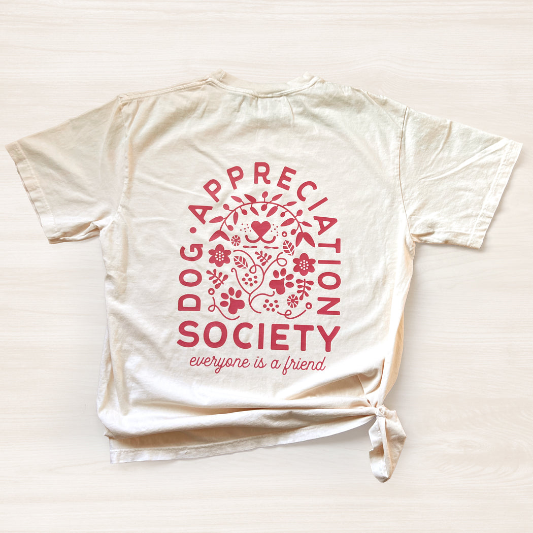 Back view of ivory Dog Appreciation Society Graphic T-Shirt with full graphic design.