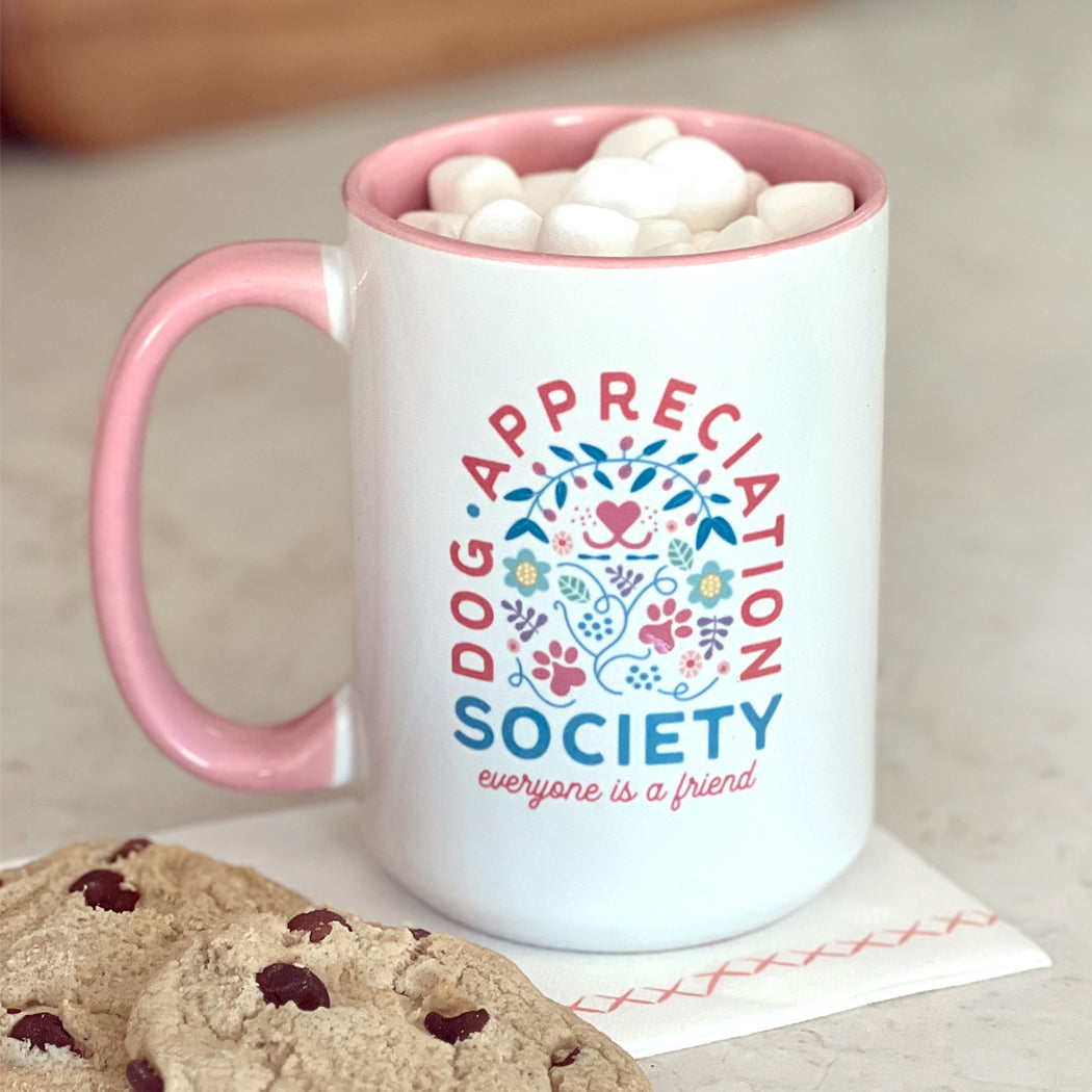 Front view of Dog Appreciation Society Mug with pink interior and handle.