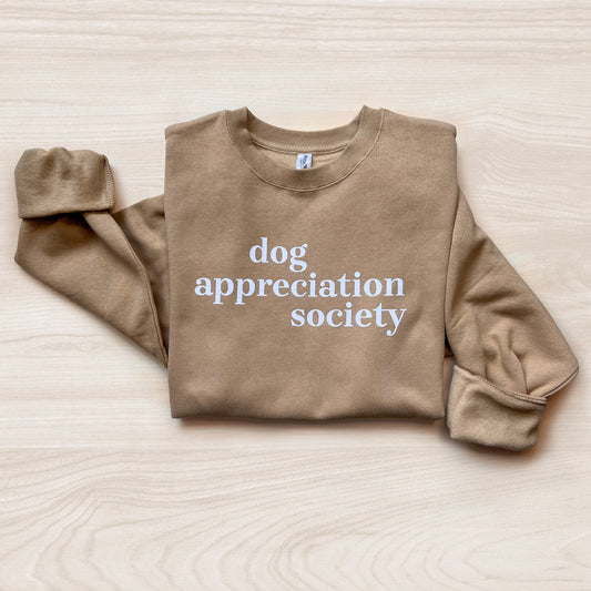 Front view of Dog Appreciation Society Sweatshirt in Sandstone color with white typography.