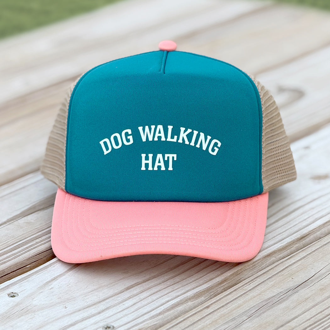 Front view of tri-colored dog walking trucker hat with mesh back and slightly curved visor, designed for dog lovers