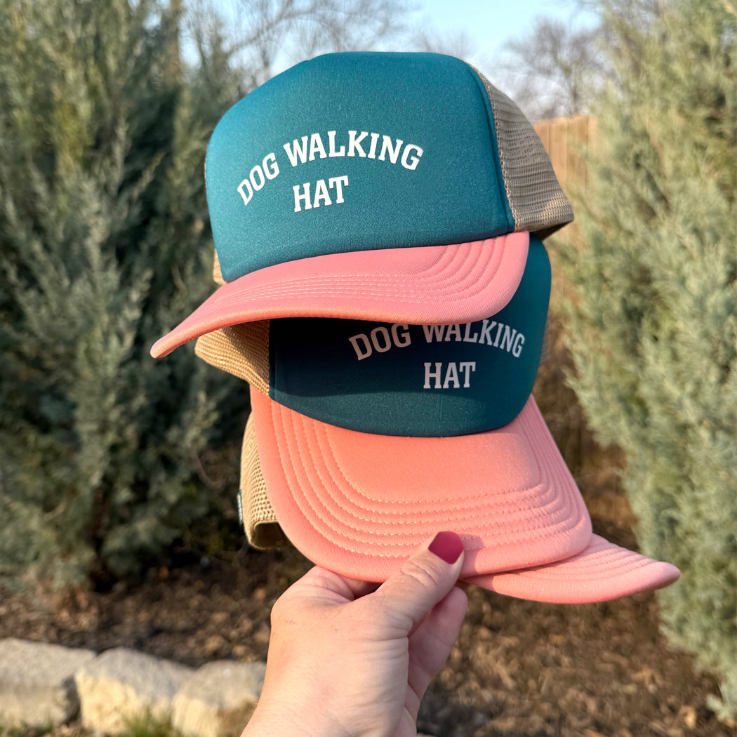 Front view of tri-colored dog walking trucker hat with mesh back and slightly curved visor, designed for dog lovers
