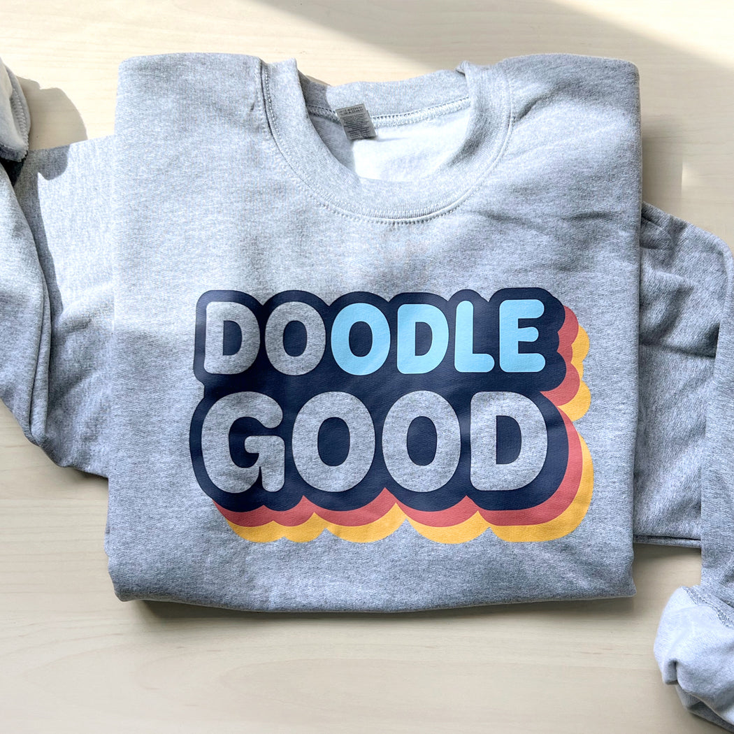 Gray unisex sweatshirt with 'Doodle Good. Do Good.' text, perfect for dog lovers and doodle owners.