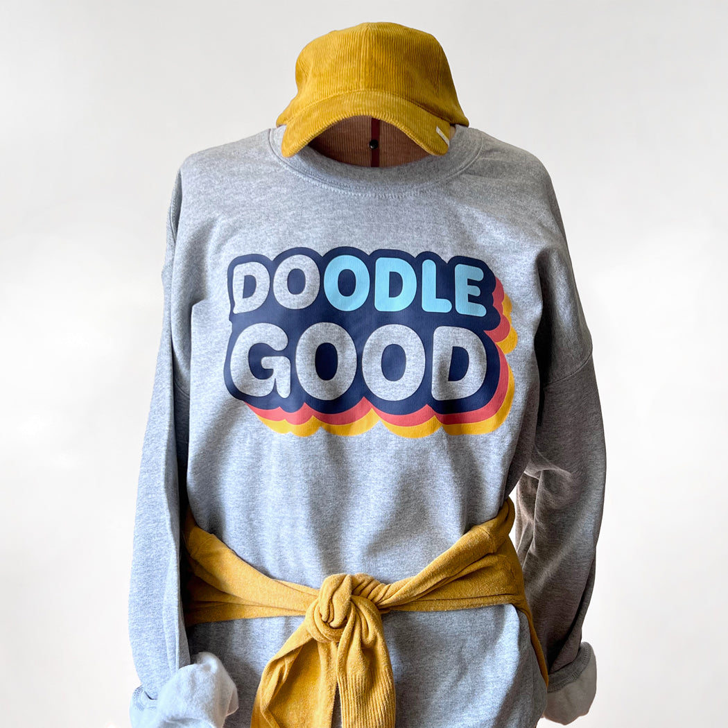 Gray unisex sweatshirt with 'Doodle Good. Do Good.' text, perfect for dog lovers and doodle owners.