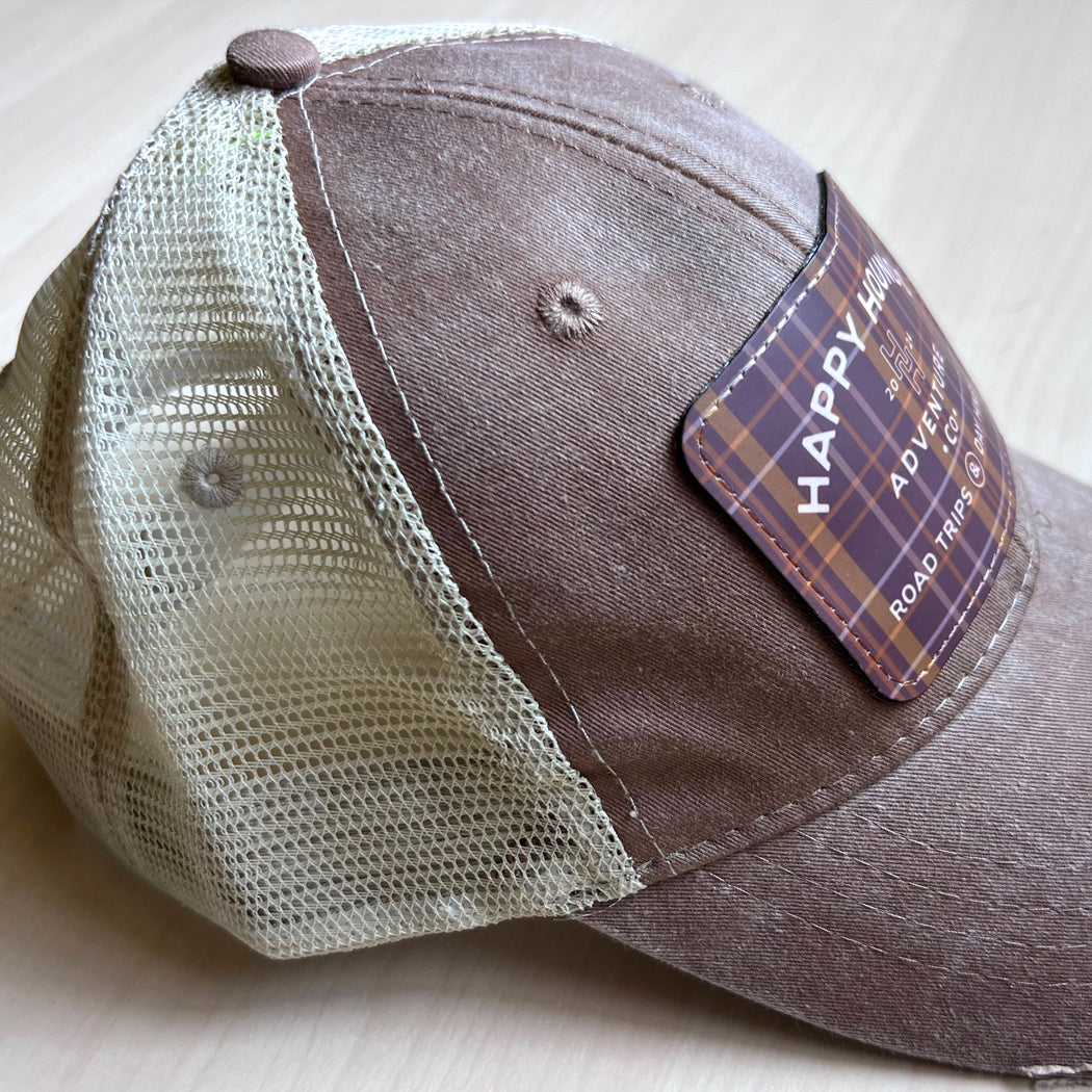 Happy Hounds distressed trucker hat with embroidered patch and mesh back.