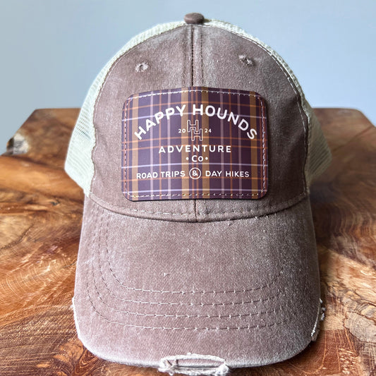 Happy Hounds distressed trucker hat with embroidered patch and mesh back.
