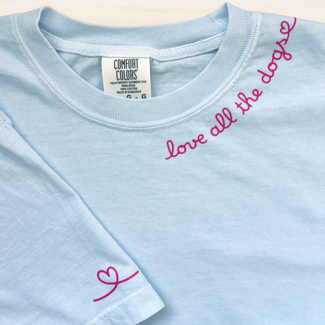 Cute dog lover t-shirt featuring ‘Love All the Dogs’ text in a stylish design.
