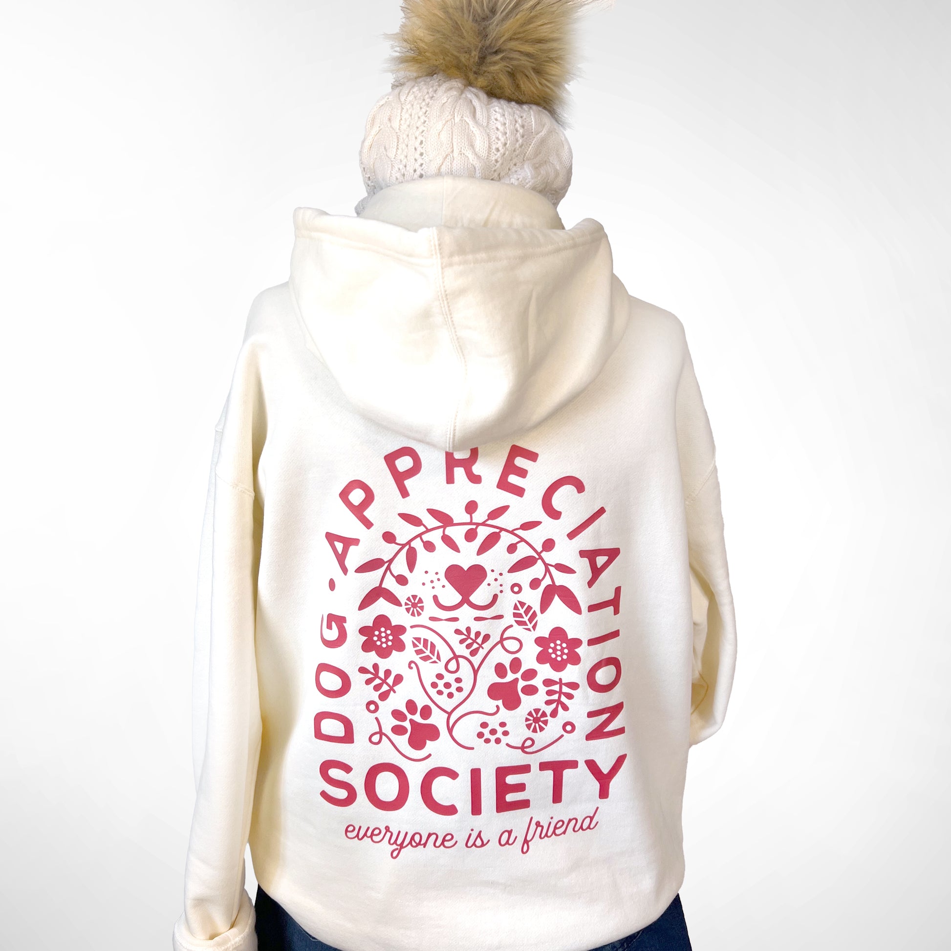 Back view of bone Dog Appreciation Society Hoodie with hand-illustrated design.