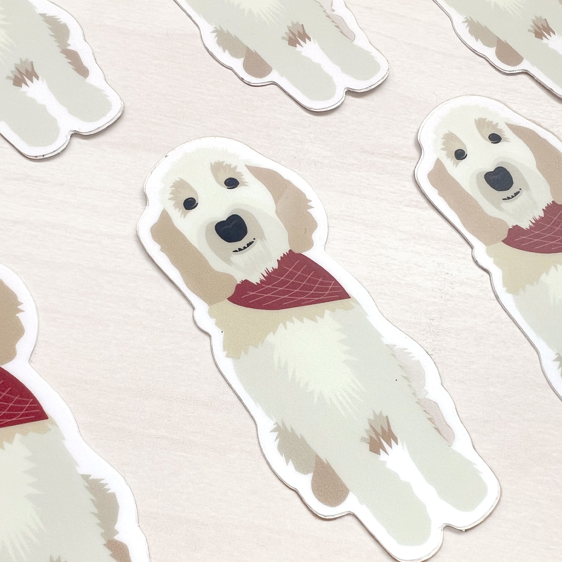 Doodle dog sticker featuring a cream-colored dog wearing a red bandana.