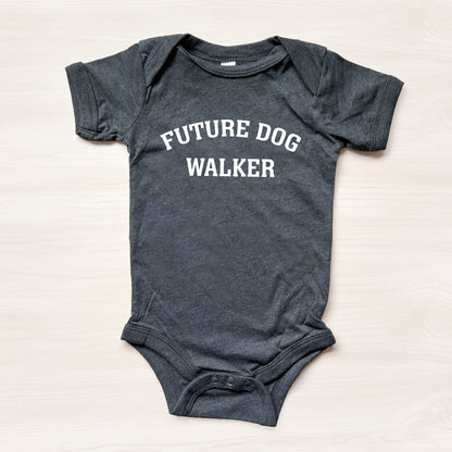 Gray baby onesie with 'Future Dog Walker' text on a light beige background