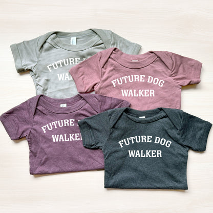Four baby shirts with 'Future Dog Walker' text on a light background