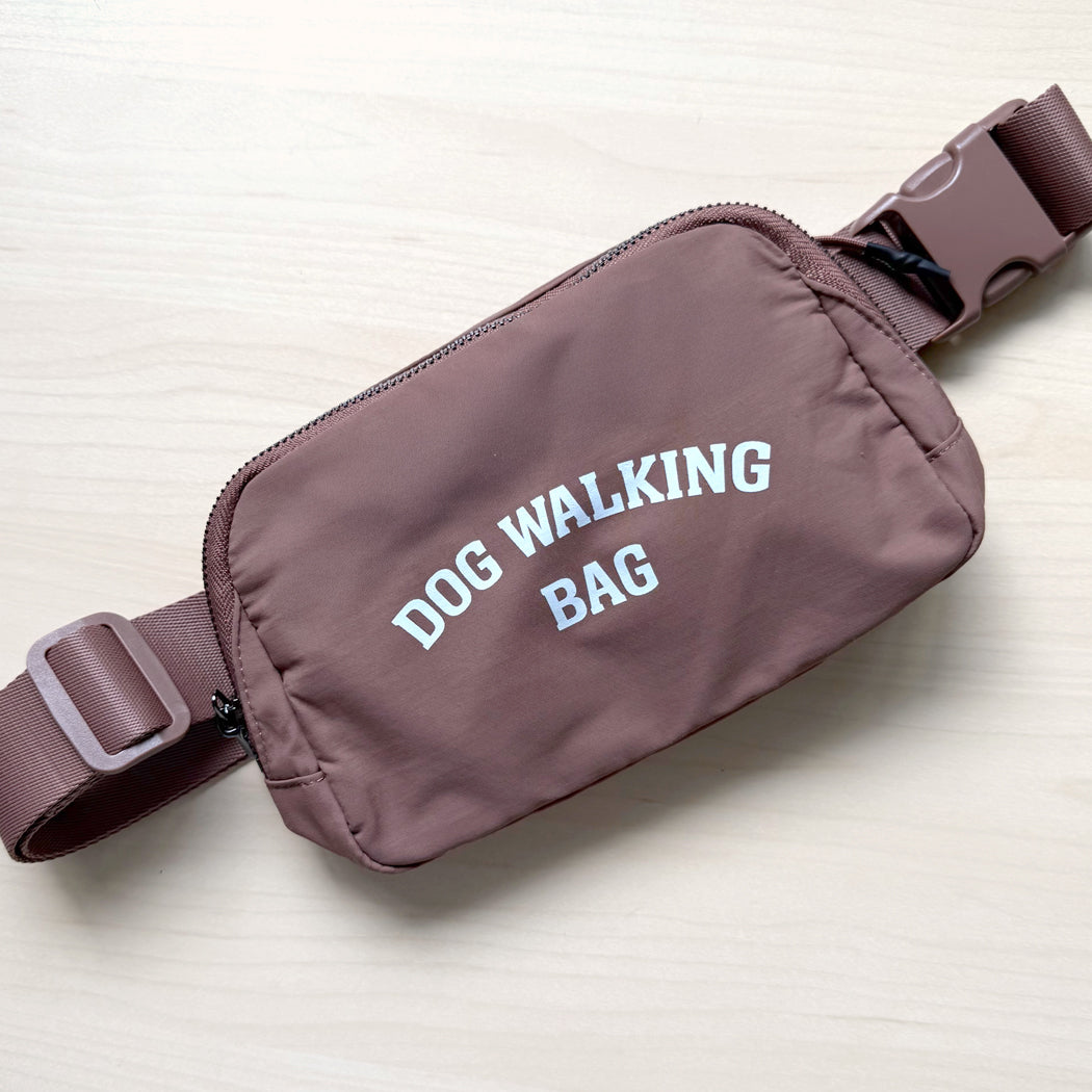 Dog Walking Bag shown in brown with adjustable strap and front zipper pocket