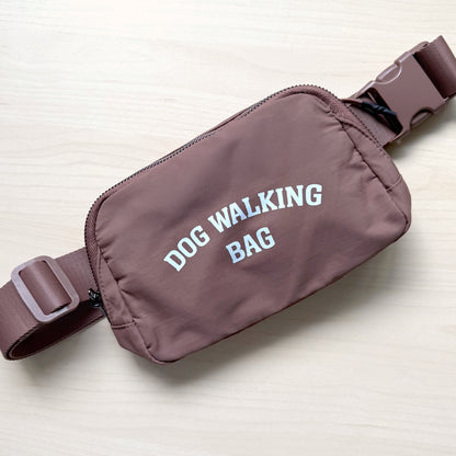 Dog Walking Bag shown in brown with adjustable strap and front zipper pocket