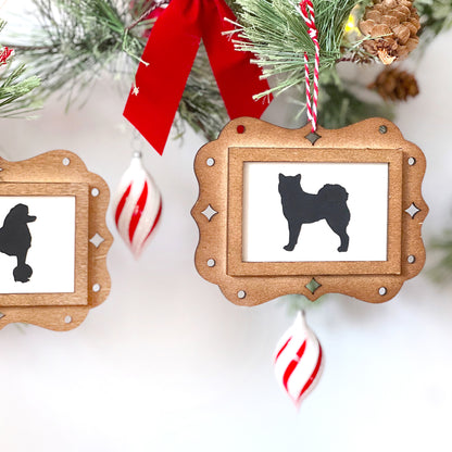 Wooden Christmas ornament with dog silhouette on a white background