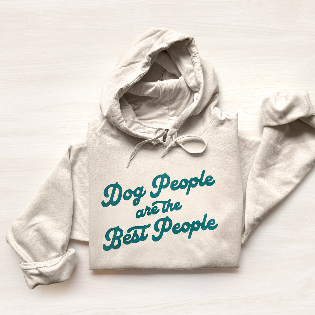 White hoodie with teal text 'Dog People are the Best People' on a light background