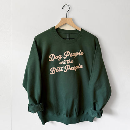 Green sweatshirt with 'Dog People are the Best People' text on a hanger against a white background