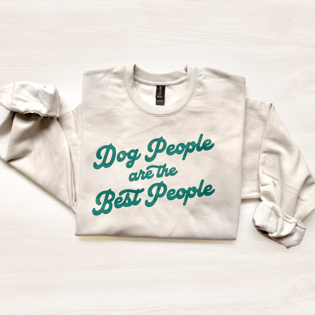 White sweatshirt with teal text 'Dog People are the Best People' on a light background