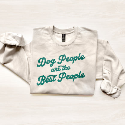 White sweatshirt with teal text 'Dog People are the Best People' on a light background