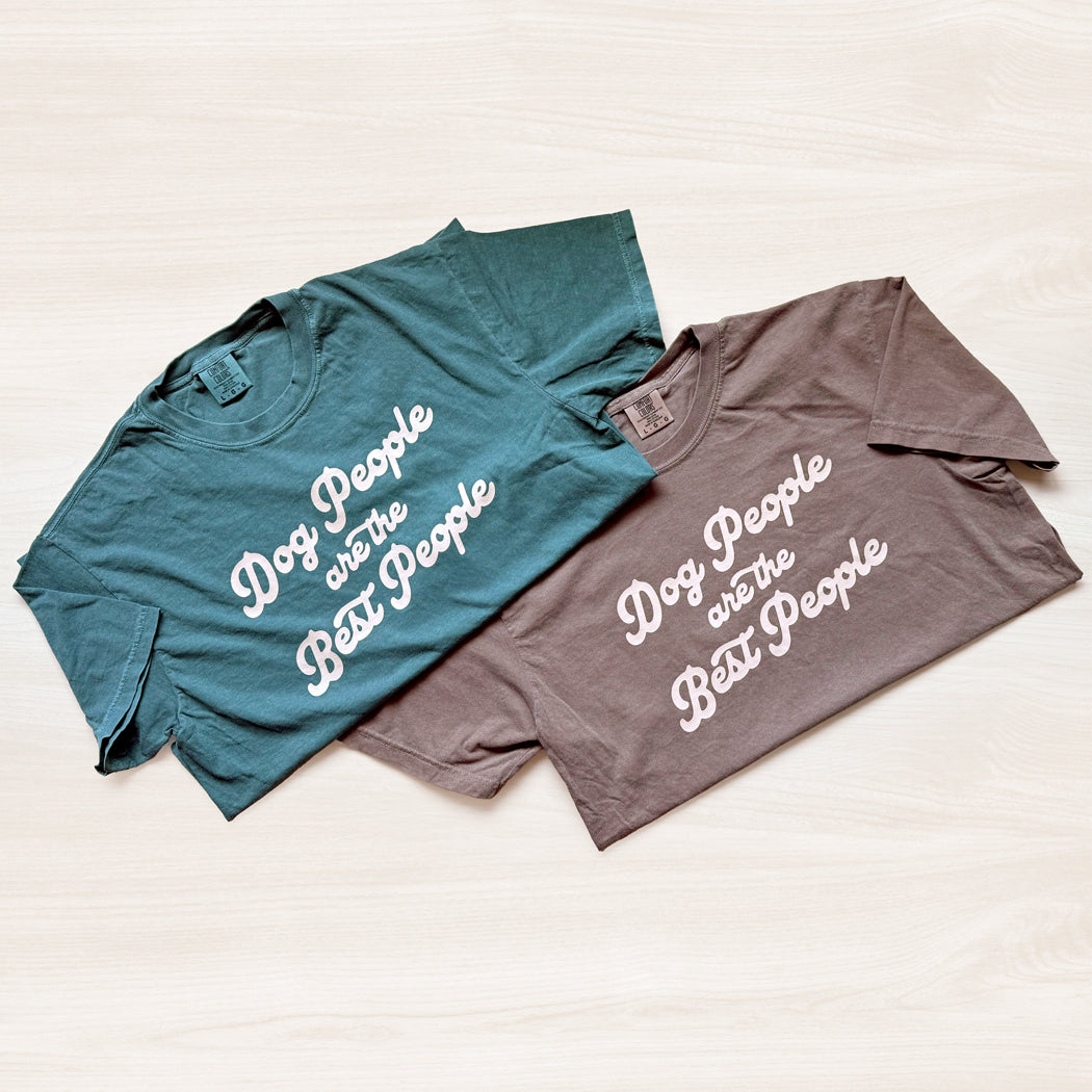 Two t-shirts, one blue and one gray, with 'Dog People are the Best People' text on a light background.