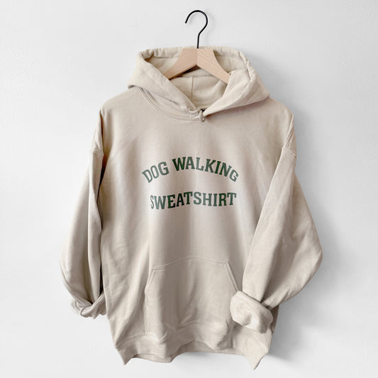 Beige hoodie with 'DOG WALKING SWEATSHIRT' text on a white background
