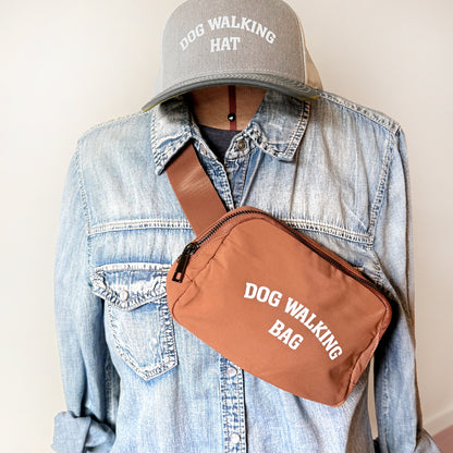 Dog Walking Bag shown in brown with adjustable strap and front zipper pocket