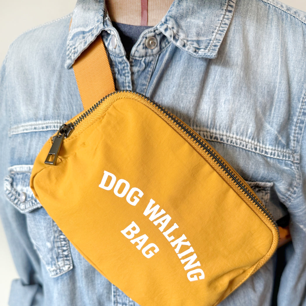 Dog Walking Bag closeup shown in yellow with adjustable strap and front zipper pocket