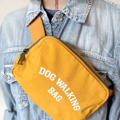 Dog Walking Bag closeup shown in yellow with adjustable strap and front zipper pocket