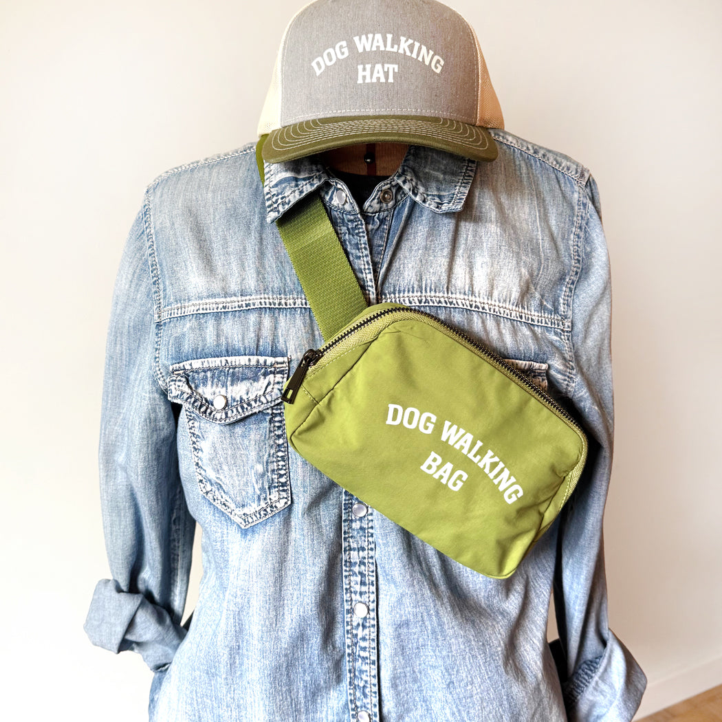 Dog Walking Bag shown in green with adjustable strap and front zipper pocket