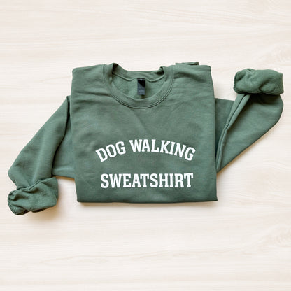 Green sweatshirt with 'DOG WALKING SWEATSHIRT' text on a light background