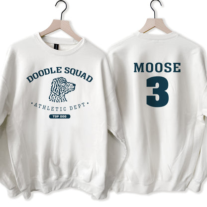 Two white sweatshirts with 'Doodle Squad Athletic Dept' and 'Moose 3' text on hangers.