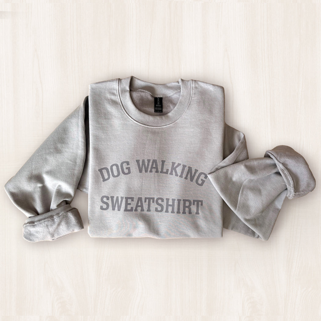Gray sweatshirt with 'DOG WALKING SWEATSHIRT' text on a light background