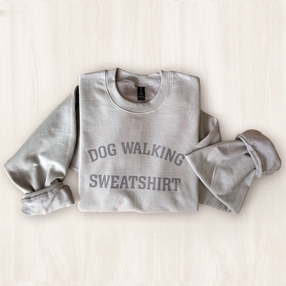 Gray sweatshirt with 'DOG WALKING SWEATSHIRT' text on a light background