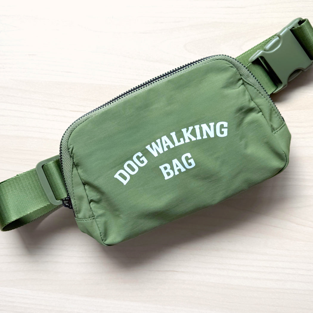 Dog Walking Bag shown in green with adjustable strap and front zipper pocket