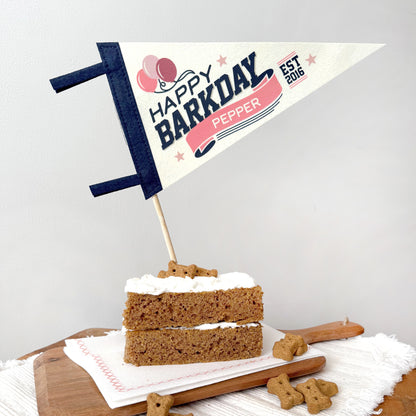 Dog birthday cake with 'Happy Barkday' flag on a white background