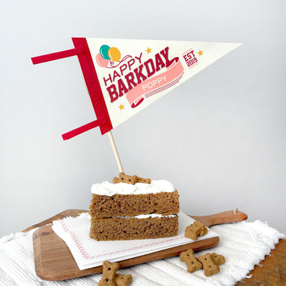 Dog birthday cake with 'Happy Barkday' sign on a white background