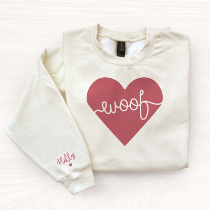 Off whtie sweatshirt with a red heart and 'woof' text on a white background