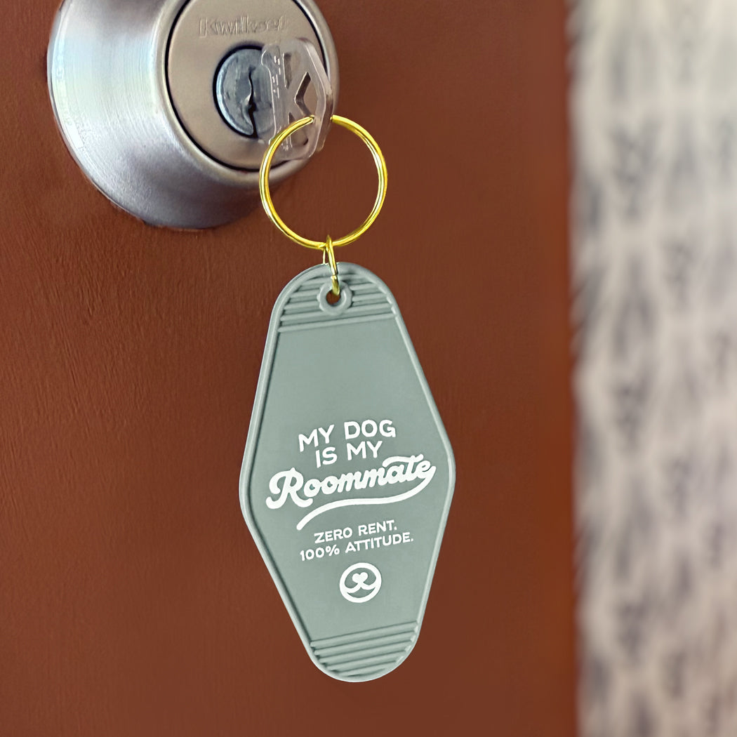 My Dog Is My Roommate retro motel keychain with white lettering on green plastic