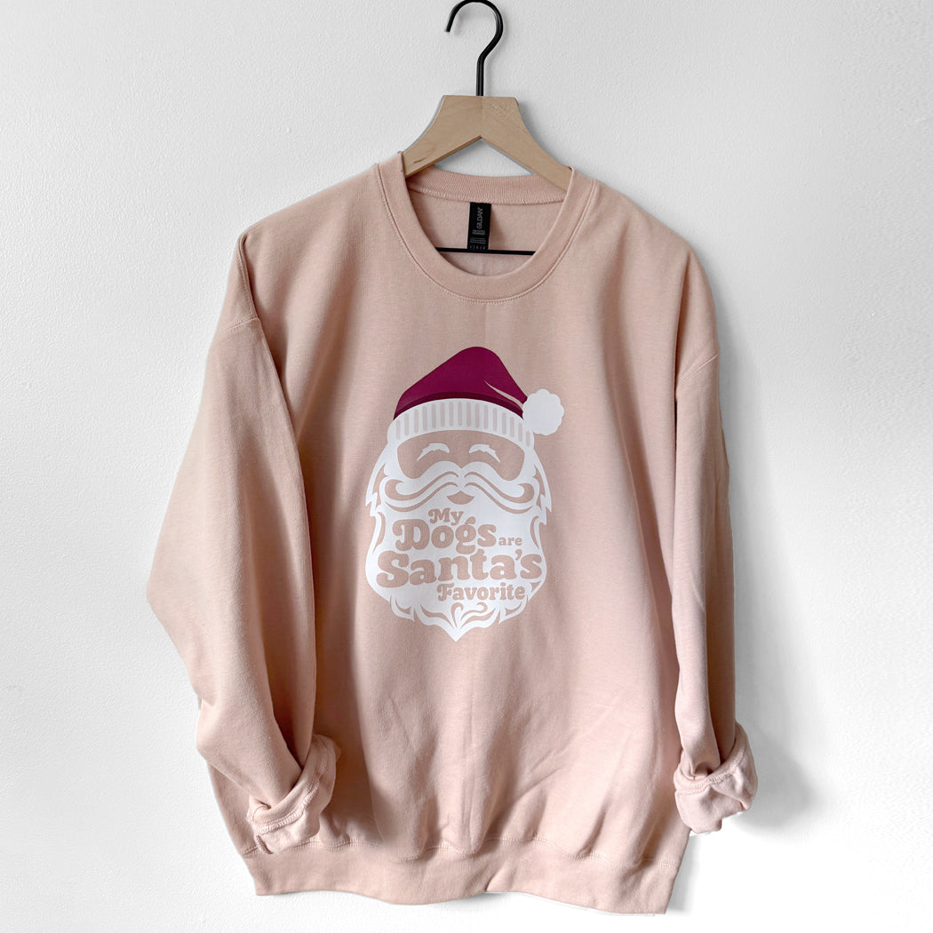 Pink sweatshirt with Santa graphic and text on a white background