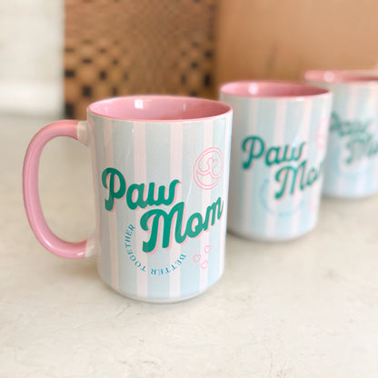 Mugs with 'Paw Mom' text on a light surface