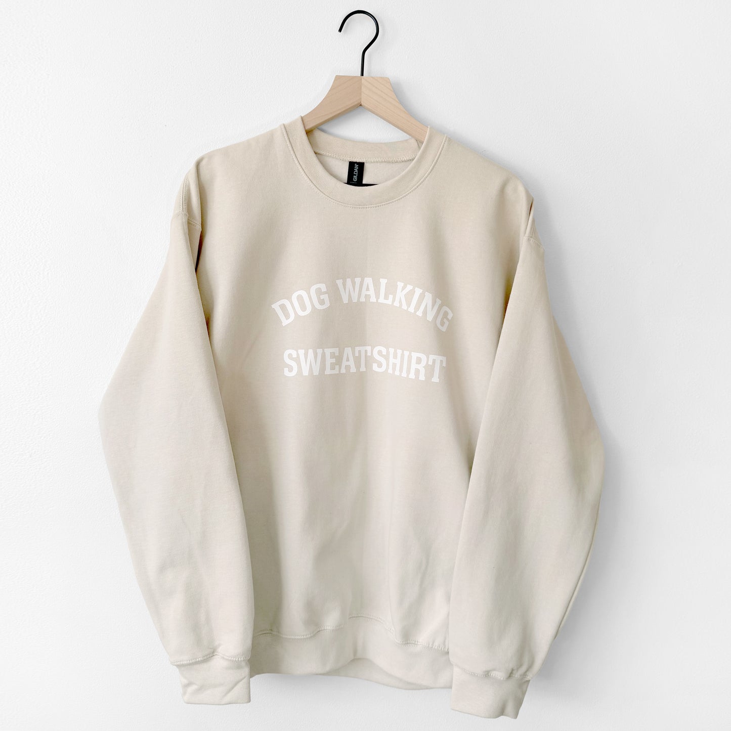 Beige sweatshirt with 'DOG WALKING SWEATSHIRT' text on a white background
